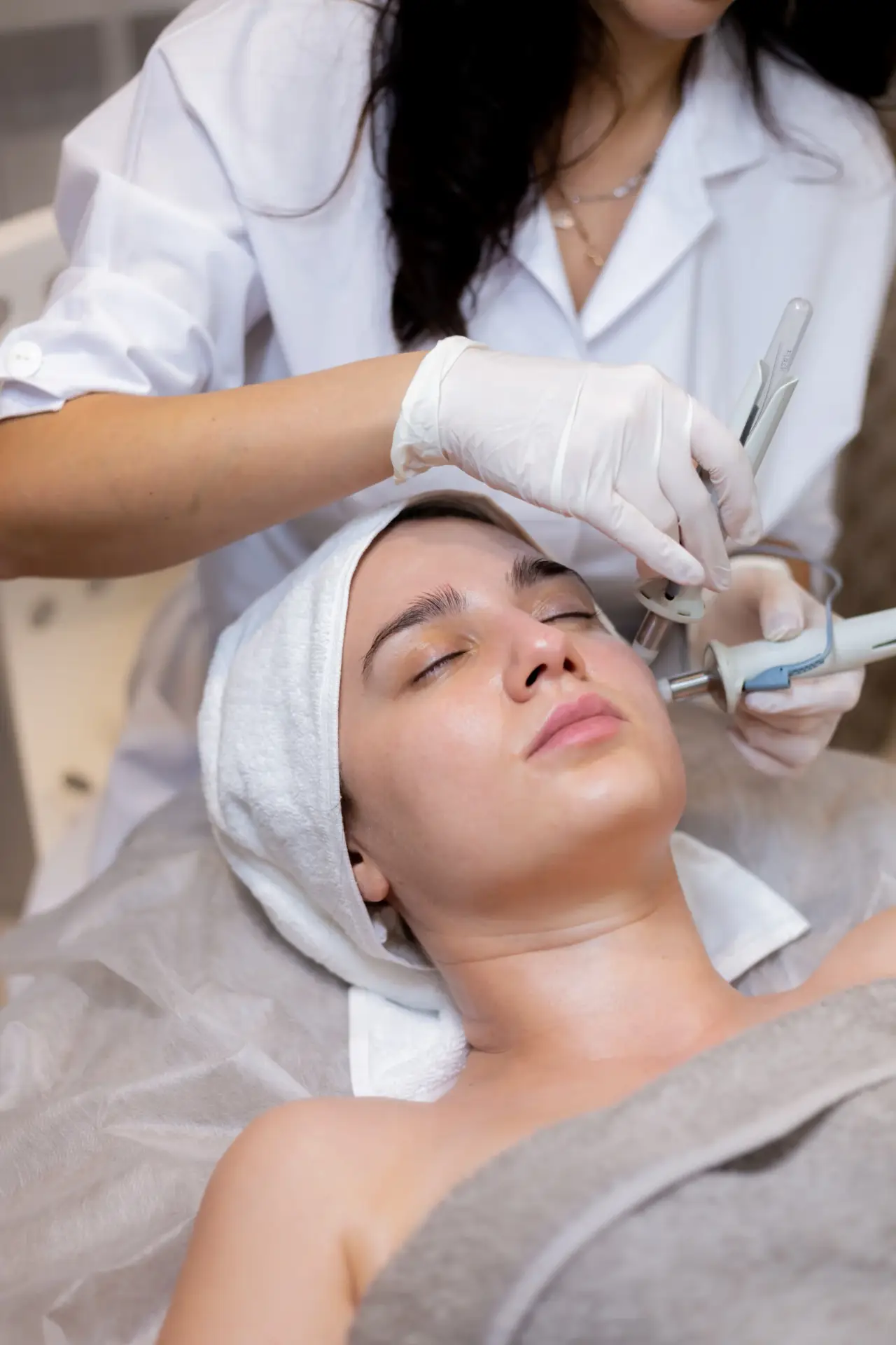 young beautiful girl lies beautician s table receives procedures scaled